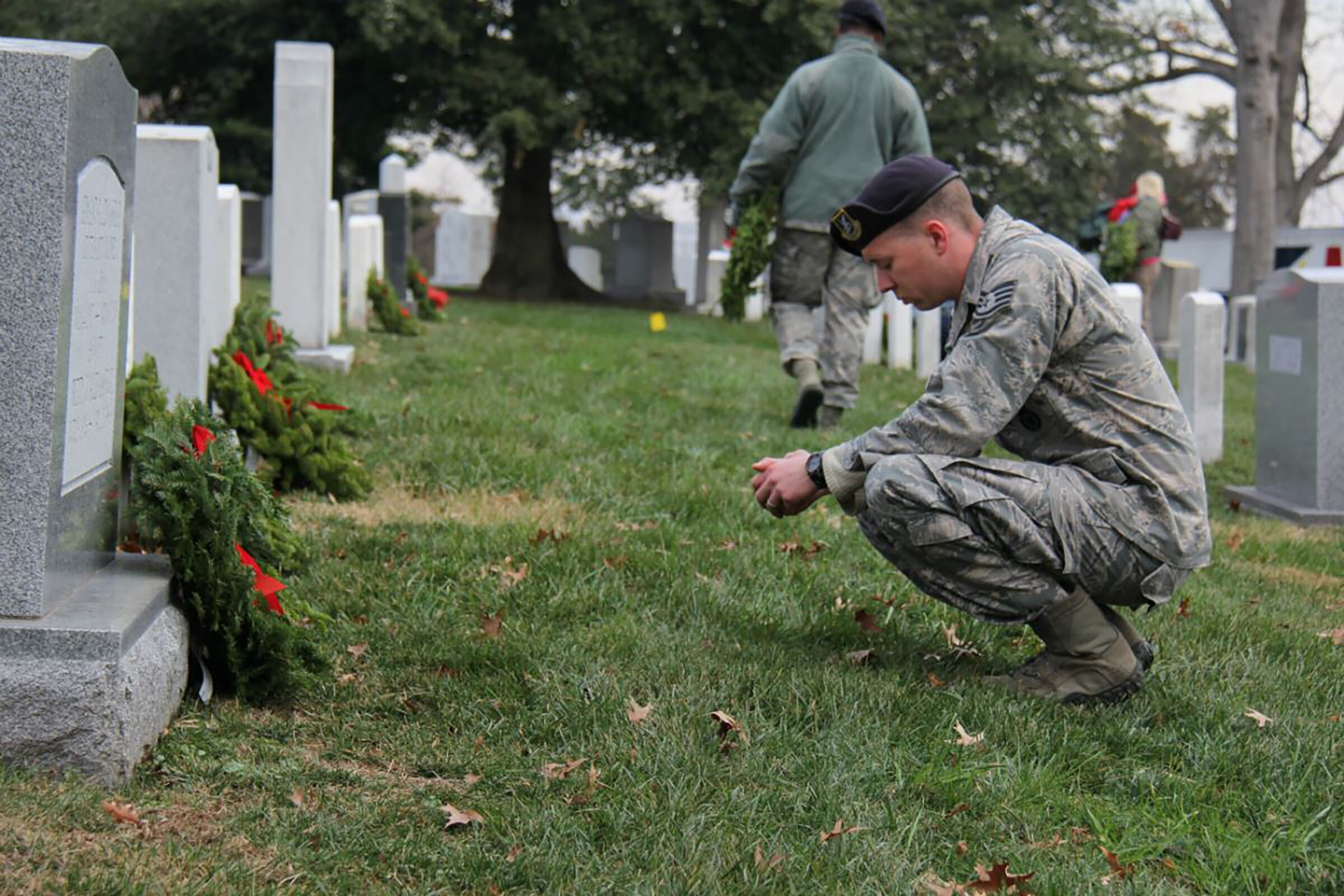 Man in uniform visiting grave
